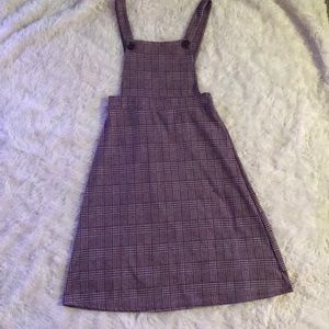 A suspender dress/skirt, knee length button strap